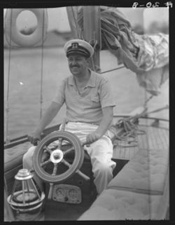 Milton Matter at wheel of yacht