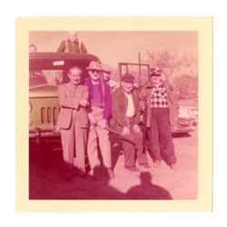 Roy Howard and hunting party posing with automobile