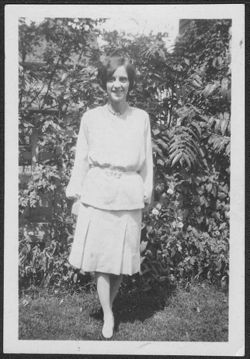 Georgia Carmichael standing in front of bushes.