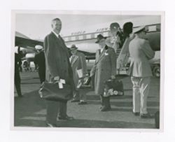 Roy Howard and other men after disembarking a plane