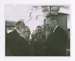 Roy and Jack Howard talking with others