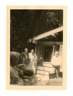 Men stand by outdoor structure at Bohemian Grove