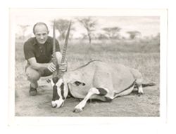 "White hunter" holding a dead Oryx