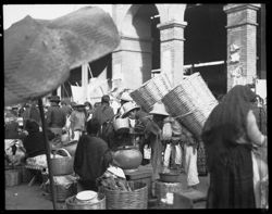 Baskets on backs of Indians, moving in Oaxaca Market