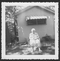 Clara Hall sitting out in the yard.