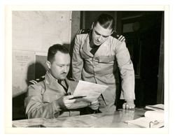 Jack Howard and another man looking at a document