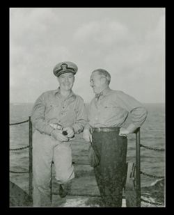 Roy W. Howard and military man posing for photograph on ship