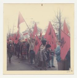 Marchers with United Farm Workers flags