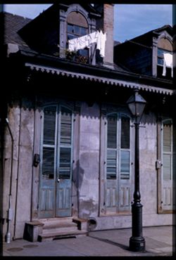 Faded green shutters and lamp post, New Orleans
