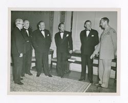 Roy Howard and other men talking together