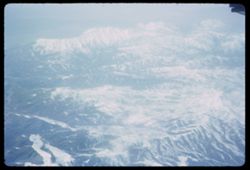 Pan-Am jet flight Los Angeles - London over snow-covered Rocky Mtns.