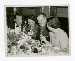 Roy Howard dining with others