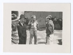Item 1150. Eisenstein, center, and four unidentified men standing in the Hacienda courtyard.