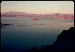 T-16= Lake Meade at Sun-set from Nevada heights back of Boulder Dam. Fortification Mtn. across the Lake.