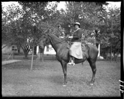 Mrs. Hetherington on horse, front of Studio