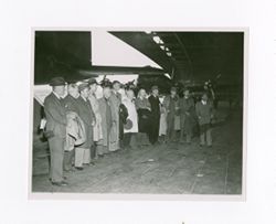 Group of men in an airplane hangar
