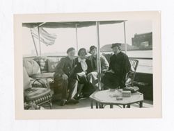 Roy Howard with women on boat