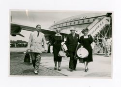 Roy and Margaret Howard and Maselle McIntyre walking away from airplane