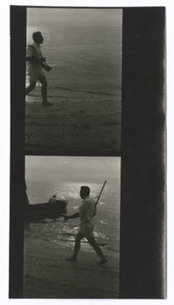 Item 0536a. Various shots of Hunter Kimbrough and young Mexican man in canoe. Two contact prints on a strip, showing Kimbrough, walking along a beach. Identical to Item 536 no. 4 above.