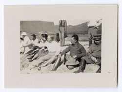 Item 1162. President Rubio seated on the sand, third from right, among a group of soldiers and civilians.