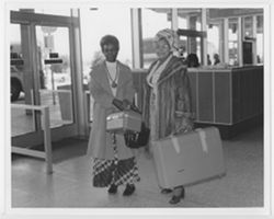 Two unidentified women, possibly Dona Irvin and Lillian Cumber, with suitcases