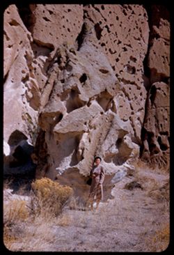Jean beside odd rock in bottom of canyon near Bandelier Nat'l Monument. New Mexico.