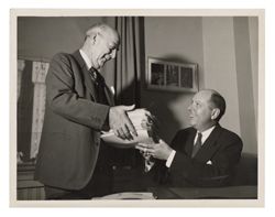 Mark Ferree and man exchanging newspapers
