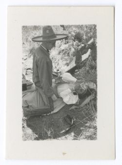 Item 0902. Man wearing sombrero kneeling over young woman ("plantation owner's daughter").