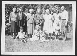 Thirteen members of the Robison family posing in yard during a family reunion at house on 3120 Graceland Avenue, Indianapolis, Indiana.