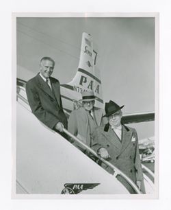 Roy Howard and other men on a ramp up to a plane