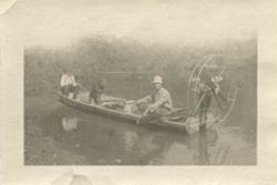 Unidentified men and dog in airboat