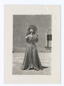 Item 1145. - 1145a. Young woman wearing checked culotte with wide legs, and Eisenstein in courtyard of Hacienda. See Items 392-394 above.