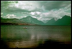 E-32 = Across McDonald Lake from Belton. Glacier Park's Peaks in Background. C.W. Cushman