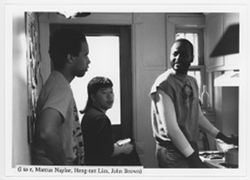 Marcus Naylor, Heng-tatt Lim, and John Brown standing in a kitchen