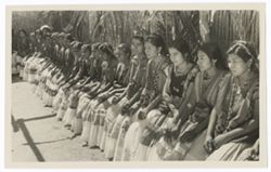 Long row of Indigenous women, seated.