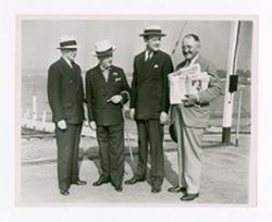 Roy Howard standing with other men