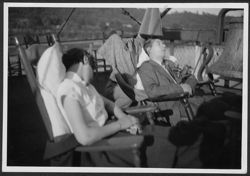 Hoagy Carmichael and an unidentified woman sleeping on the deck of a ship.