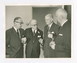 Roy Howard talking with men