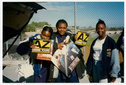 Crenshaw High School students holding promotional materials for AZ and 5th Ward Boyz.