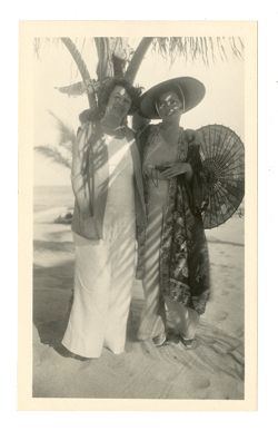 Two women standing on a beach
