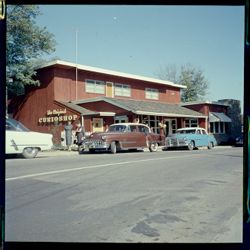 Exterior of The Original Curio Shop, with cars