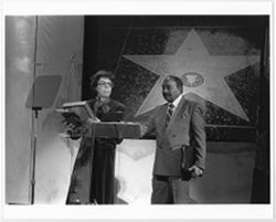 Mary Perry Smith holding plaque commemorating Oscar Micheaux's Hollywood Walk of Fame star