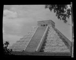 Item 0155. Various similar views of the Castillo, some with trees and/or other foliage visible. Medium shot with bush in lower left corner and leafy branch in upper right.