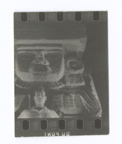 Item 0921. Probably taken at National Museum of Anthropology. Young man in front of stone statue of Chalchihuitlicue, water goddess. See Items 436-436a above.