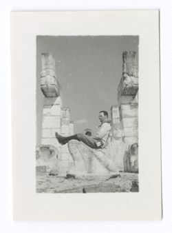 Item 1036. Unidentified man in knee-high laced boot, jodhpurs, kerchief seated on Chac-Mool.