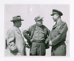 Roy Howard discussing with military personnel