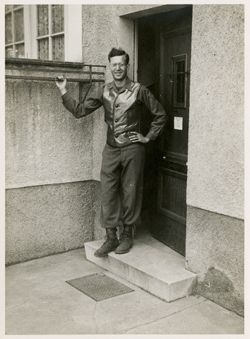 Malcolm  Fleming posing in doorway to his house in Gotha, Germany