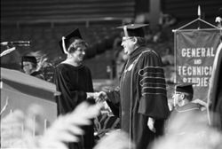 President John Ryan shakes hands with IU South Bend graduate, 1970s