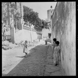 Street scene near group of children, Barranca St.