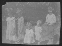 Five unidentified children playing outside.
